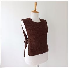 a woman's brown sweater vest on a mannequin