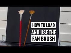 two brushes sitting on top of a table next to a sign that says how to load and use the fan brush