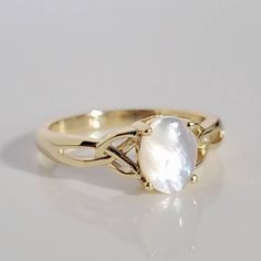 Wearing A Celtic Ring Symbolizes Friendship, Love And Loyalty Throughout The World. With Their Distinctive Design, These Rings Are Easily Recognizable And Can Trace Their History Back Several Hundred Years To The Rugged Irish Coast. Top Of Ring Height: 8mm Top Of Ring Width: 6mm Band Width: 3.2mm Shank Width: 1.8mm Stone Material: Mother Of Pearl Center Stone Size: 8mm X 6mm Stone Shape: Oval Total Number Of Stones: 1 Stone Setting: Prong Metal: 925 Sterling Silver Plating: 14k Yellow Gold Finis Celtic Band Ring, Mother Of Pearl Engagement Ring, Mother Of Pearl Wedding Ring, Celtic Engagement Ring, Scottish Ring, Gold Celtic Rings, Pearl Ring Gold, Irish Coast, Love And Loyalty