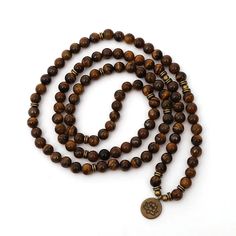 Enhance your spiritual journey and elevate your style with our Tiger Eye Stone Beads Strand Charm Chakra Bracelet or Necklace. Designed for both men and women, this versatile piece can be worn as a multi-layer wrapped bracelet or a stunning necklace. Crafted from high-quality 8mm tiger eye stone beads, this 108 Mala bracelet is perfect for yoga, meditation, and bringing balance and good fortune into your life. The 108 beads represent the sacred number in Buddhism, symbolizing the completion of spiritual journeys and the repetition of mantras. Each bead is meticulously hand-strung to ensure durability and comfort. The bracelet features symbolic charms, including Lotus, OM, and Buddha, adding a unique and meaningful touch to your spiritual practice. Ideal for yoga practitioners and meditatio What Is Spirituality, Aventurine Jewelry, Tiger Eye Jewelry, Rose Quartz Jewelry, Tigers Eye Necklace, 108 Mala Beads, Men Wallet, Healing Necklace, 108 Bead