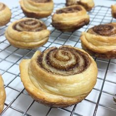 several cinnamon rolls cooling on a wire rack