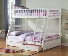 a white bunk bed sitting on top of a wooden floor