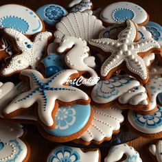 cookies decorated with blue and white icing on a table