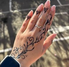 a woman's hand with tattoos on it