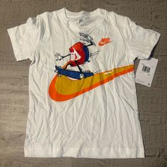 Nike Boys T Shirt | White | Size 6 Playful White Tops With Character Print, Playful White Tops With Graphic Print, Nike Cotton Shirt For Summer, Playful White Nike Tops, Sporty Cotton Tops With Cartoon Print, Fun White Pre-shrunk Shirt, Playful White Crew Neck Shirt, White Tops With Character Print For Spring, White Character Print Top For Spring