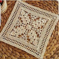 a woven placemat sitting on top of a wicker basket next to a pine cone