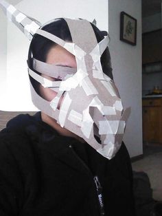 a woman wearing a horse mask with duct tape on her face