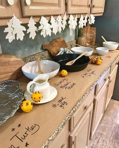 the kitchen counter is covered with bowls and plates