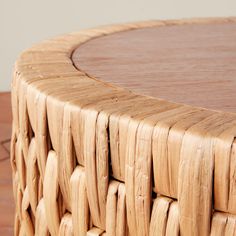 a close up view of a wooden table with wicker on the top and bottom