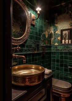 a green tiled bathroom with a gold sink and round mirror above the toilet area is lit by two lights