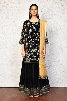 Black kurta with contrast floral embroidery. Paired with a lehenga, highlighted with floral embroidered hem. Comes along with a dupatta.
Components: 3
Pattern: Embroidery
Type Of Work: Floral
Neckline: Round Neck
Sleeve Type: Three Quarter Sleeves
Fabric: Kurta and Lehenga: Velvet, Dupatta: Chanderi, Lining: Shantoon
Color: Black
Other Details: 
Length:
Kurta: 36 inches
Lehenga: 40 inches
Occasion: Mehendi and Haldi - Aza Fashions Festive Black Floral Embroidered Palazzo Set, Anarkali Style Black Palazzo Set With Floral Embroidery, Black Anarkali Palazzo Set With Floral Embroidery, Designer Black Lehenga For Transitional Season, Black Designer Lehenga For Transitional Season, Designer Black Transitional Lehenga, Festive Black Palazzo Set With Floral Embroidery, Transitional Designer Black Lehenga, Elegant Black Sharara With Floral Embroidery