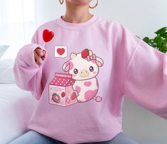 PLEASE NOTE: This is a UNISEX sweater. If you want an oversized look then consider ordering up a size. This cute strawberry cow sweater will look adorable on you! Makes for a great gift to give to your friends as well. The collar is ribbed knit, so it retains its shape even after washing. There are no itchy side seams on these sweaters. .: 50% cotton, 50% polyester .: Medium-heavy fabric (8.0 oz/yd² (271.25 g/m .: Loose fit .: Sewn-in label .: Runs true to size Oversized Kawaii Sweatshirt For Streetwear, Oversized Kawaii Sweatshirt With Cartoon Print, Oversized Kawaii Cartoon Print Sweatshirt, Cute Oversized Letter Print Sweater, Oversized Kawaii Sweatshirt With Long Sleeves, Oversized Cute Sweater With Letter Print, Pink Oversized Harajuku Sweatshirt, Oversized Pink Harajuku Sweatshirt, Oversized Pink Harajuku Style Sweatshirt