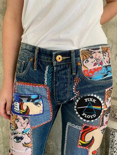 a person wearing jeans with patches on them