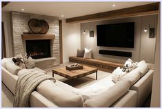 a living room filled with furniture and a flat screen tv mounted on the wall above a fire place