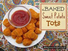 baked sweet potato tots on a white plate with ketchup in a bowl