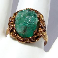 "Vintage Chinese Export ring, made of approx. 20 K (.833) yellow gold. It features dragon figure around the rough Emerald crystal. Band is textured. It is marked \"BO\" and \"JS\" on the inside. This stunning ring is a size 8, 3/4\" at the widest and weighs 5.9 grams. The stone is a little loose, needs to see a jeweler. EA72" Collectible Gold Emerald Gemstone Ring, Collectible Gold Emerald Ring With Gemstone, Gold Emerald Ring Collectible, Unique Gold Emerald Ring Birthstone, Emerald Crystal, Dragon Ring, Chinese Export, Ring Emerald, Druzy Ring