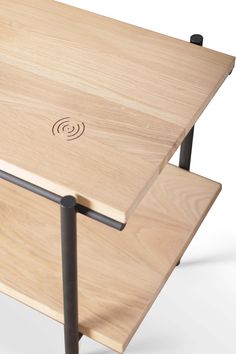 a wooden table with metal legs and an electronic device on the top that is connected to it