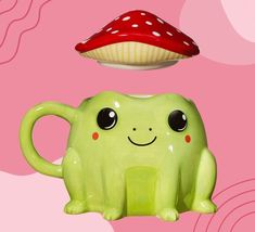 a green toy with a mushroom on top of it and a red object above it