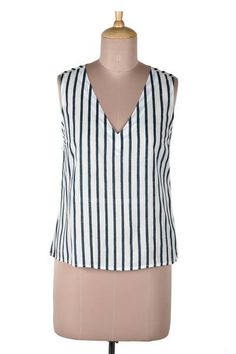 Keep cool on hot summer days with this impossibly chic sleeveless blouse designed by Indian artisan Ritu Agnihotri. Hand crafted from soft breathable viscose the top features a vertical stripe pattern that's hand block-printed in navy and white. A v-shaped neckline adds an elegant yet saucy touch. Summer Cotton V-neck Vest, Summer Cami Blouse, Summer Vest-style Cami Blouse, Summer Cami Vest Blouse, Spring Vacation Vest Tops, Cotton Sleeveless Blouse For Summer, Summer Blouse With V-neck And Vest Detail, Spring Cami Vest Blouse, Casual Summer Blouse Vest