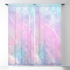 a pink and blue window curtain with an abstract design