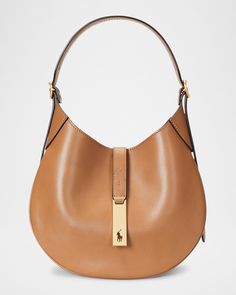 "Find RALPH LAUREN Medium Sport Leather Shoulder Bag on Editorialist. Polo Ralph Lauren shoulder bag in leather Detachable, adjustable shoulder strap Detachable, adjustable crossbody strap Can be worn as a top handle or crossbody bag Open top with magnetic closure Interior, one slip pocket Approx. 10\"H x 10\"W x 1\"D Imported" Ralph Lauren Leather Bags With Adjustable Strap, Leather Saddle Shoulder Bag With Detachable Handle, Luxury Ralph Lauren Office Bag, Ralph Lauren Shoulder Bag With Palladium Hardware, Ralph Lauren Leather Bags With Palladium Hardware, Ralph Lauren Classic Shoulder Bag With Gold-tone Hardware, Ralph Lauren Formal Shoulder Bag With Removable Pouch, Ralph Lauren Shoulder Bag With Palladium Hardware For Everyday, Ralph Lauren Top Handle Bag With Gold-tone Hardware