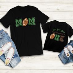 the mom and son shirts are on display next to each other, with one holding a football