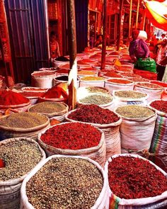 many baskets filled with different types of spices