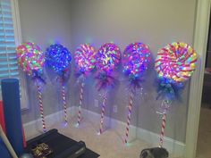 several lollipops are lined up against the wall