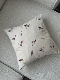 a pillow with skis on it sitting on a couch