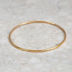 This fine hand forged bangle has a hammered finish. Beautiful worn on its own, or layered with our other fine bangles. Approx. width: 2mm. Approx. gold weight: 7 grams in 9ct. Classic Hammered Yellow Gold Bracelets, Hammered Yellow Gold Bangle Bracelet, Hand Forged Yellow Gold Bangle Bracelets, Hammered Yellow Gold Bangle For Everyday, Everyday Hammered Yellow Gold Bangle, Minimalist Hammered Bracelet Bangle, Minimalist Hammered Bangle Bracelet, Hammered Minimalist Bangle, Adjustable Hammered Yellow Gold Bangle