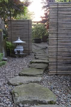 a stone path in the middle of a garden