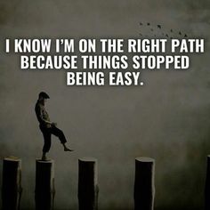 a man standing on top of wooden posts with the words i know i'm on the right path because things stopped being easy