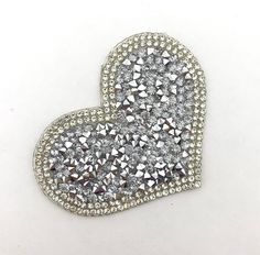 a heart shaped brooch with lots of diamonds