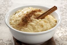 a white bowl filled with mashed potatoes and cinnamon