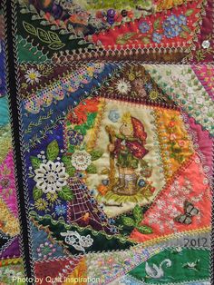 a close up of a quilt with many different colors and designs on the front, back and sides