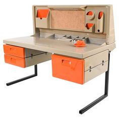 an orange and beige desk with two drawers on each side, one drawer open to the other