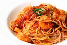 pasta with shrimp and tomato sauce in a white bowl