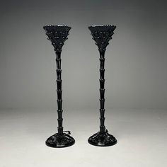 two black candlesticks sitting side by side