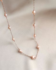 💗 Delicate Rose Gold Pearl Necklace with pink freshwater pearls & 14K Rose Gold Filled ✨ Dainty & Elegant. Simply beautiful necklace/ choker. A perfect gift & affordable treat for yourself.• Pearl size: 4-5 mm• Model picture is wearing 15" in length (model is 155 cm/ 5'1" height)• Handmade with genuine pink Freshwater Pearls. All metal parts are high-quality 14K Rose Gold Filled. It also can be made with 14K Gold-filled or Sterling Silver.• Gold-filled chain is known for its lasting quality. Th Pink Pearl Necklace Rose Gold, Delicate Pearl Necklace, Rose Gold Pearl Chain Necklace, Elegant Rose Gold Pearl Necklace With Delicate Chain, Feminine Rose Gold Necklace With Pearl Chain, Feminine Rose Gold Pearl Chain Necklace, Rose Gold Single Strand Necklace For Anniversary, Feminine Rose Gold Necklace With Pearl Drop, Feminine Rose Gold Pearl Drop Necklace