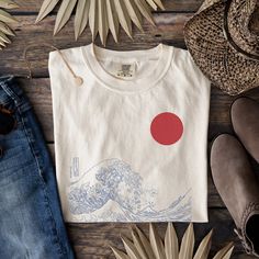 Japanese Wave T-Shirt, The Great Wave Shirt, Japanese Art Shirt, Aesthetic  Shirt, Japanese Tee, Wave Shirt, Art Shirt, Oversized Shirt 🌸Item Details:🌸 -Made to order -Unisex Tee  -Available in many sizes and colors!  -Super Versatile -For an oversized look I recommend sizing up -Japanese Wave Art Tee ⭐️Materials: ⭐️ COMFORT COLORS  ⭐️100% ring-spun cotton ⭐️Medium fabric (6.1 oz/yd² (206.8 g/m ⭐️Relaxed fit ⭐️Sewn-in twill label **Please review size chart in photos prior to purchasing ✨PRODUCTION TIME✨ Production takes about 1-3 days. Within this timeframe you will receive an email letting you know your item has shipped with a tracking number for your item. ✨SHIPPING TIME✨ Shipping takes about 2-5 days. ✨CARE INSTRUCTIONS ✨ COMFORT COLORS -Wash separately to avoid color bleeding or wash Artistic Relaxed Fit Shirt With Screen Print, Artsy White Crew Neck T-shirt, Artistic White Relaxed Fit Shirt, Artistic White Shirt With Screen Print, Artsy Crew Neck Shirt With Relaxed Fit, Artsy Cotton Shirt With Graphic Design, Artistic Cotton Crew Neck Shirt, Japanese Wave, The Great Wave