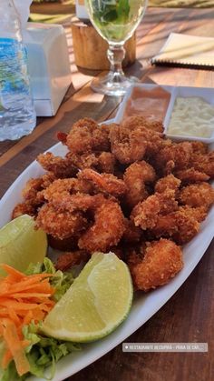 fried shrimp with carrots, lettuce and celery on a white plate