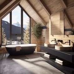 a bathroom with a large tub and two sinks in front of a window that looks out onto the mountains