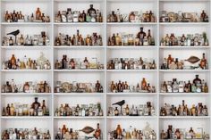 shelves filled with lots of different types of bottles and glasses on top of each other