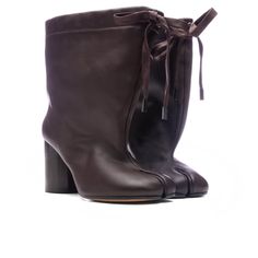 The Brown Tabi Drawstring Ankle Boot in 'Chic Brown' from Maison Margiela. This Italian-made boot features a Nappa upper with a leather sole and a drawstring top closure. It has a leather lining, a slouchy shaft, and a distinctive Tabi split toe. The boot stands on a heel approximately 75mm high with a shaft height of around 165mm. Nappa upper with leather sole Made in Italy Drawstring top closure Leather lining Slouchy shaft Tabi split toe Approx 75mm/ 3 inch heelApprox 165mm/ 6.5 inch shaft St Leather Ankle Boots With Lace-up Fastening, Baggy Boots, Split Toe Boots, Collage Pics, Tabi Boots, Boot Stand, Drawstring Top, Med School, Cloud 9