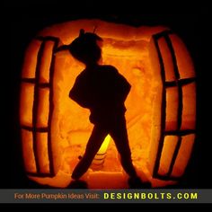 a pumpkin carved to look like a man standing in front of a barrel shaped door