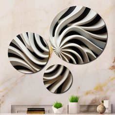 three black and white circular mirrors on a wall