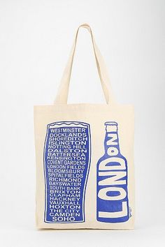 a tote bag with an image of london on the front and blue writing on the back