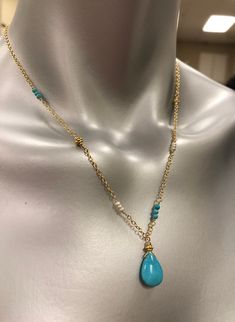 This beautiful necklace is designed with a 10mm X 15mm smooth nugget of Sleeping Beauty Turquoise (that beautiful bright blue color) and wired into a pendant with a Vermeil Bali gold bead. The pendant dangles from sparkly cable chain. Sections of the necklace are accented with tiny (2mm) smooth, round turquoise, Vermeil Bali beads that match the pendant, and tiny (2mm) white freshwater pearls for a unique one of a kind design.The look of Turquoise with gold is a beautiful change to the tradition