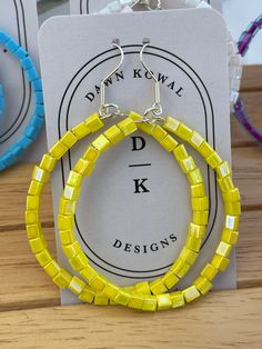 Fashion Forward Fabulous Bright Yellow Fun Hoop Earrings. Ships from a small business in Virginia Materials: Beads, wire, findings, surprisingly light weight ♥ ❤️♥ Hoop measures approximately:  2 inches round-ish Ear wires: Ear wire, silver-finished stainless steel and brass, 19mm fishhook with 6x2mm coil and open loop, 21 gauge and will come with rubber backings. Beads:  Seed bead, Miyuki, glass, opaque rainbow yellow 3.5-3.7mm square These will come to you in a gift bag with ear wire backings. Cheap Yellow Nickel-free Beaded Earrings, Adjustable Yellow Hoop Earrings With Colorful Beads, Yellow Hoop Earrings With Dangling Beads, Yellow Beaded Small Hoop Earrings, Yellow Beaded Round Hoop Earrings, Yellow Beaded Small Hoop Jewelry, Yellow Adjustable Beaded Hoop Earrings, Small Yellow Beaded Hoop Earrings, Yellow Dangle Hoop Earrings With Ear Wire