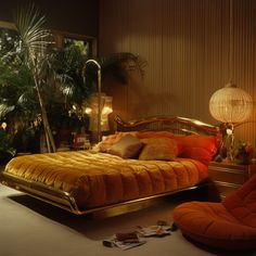 a bedroom with an orange bed and gold furniture in the middle, surrounded by palm trees